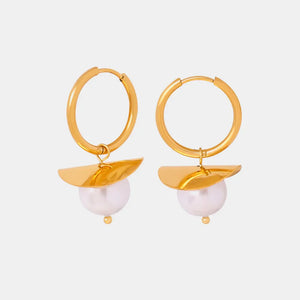 Gold hoop earrings with a petal detail and a single pearl drop.