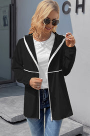 Black hooded rain coat with white trim and zipper closure.
