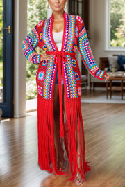 Granny square crochet duster with fringe in multi-color and red, featuring a tie waist and long sleeves.