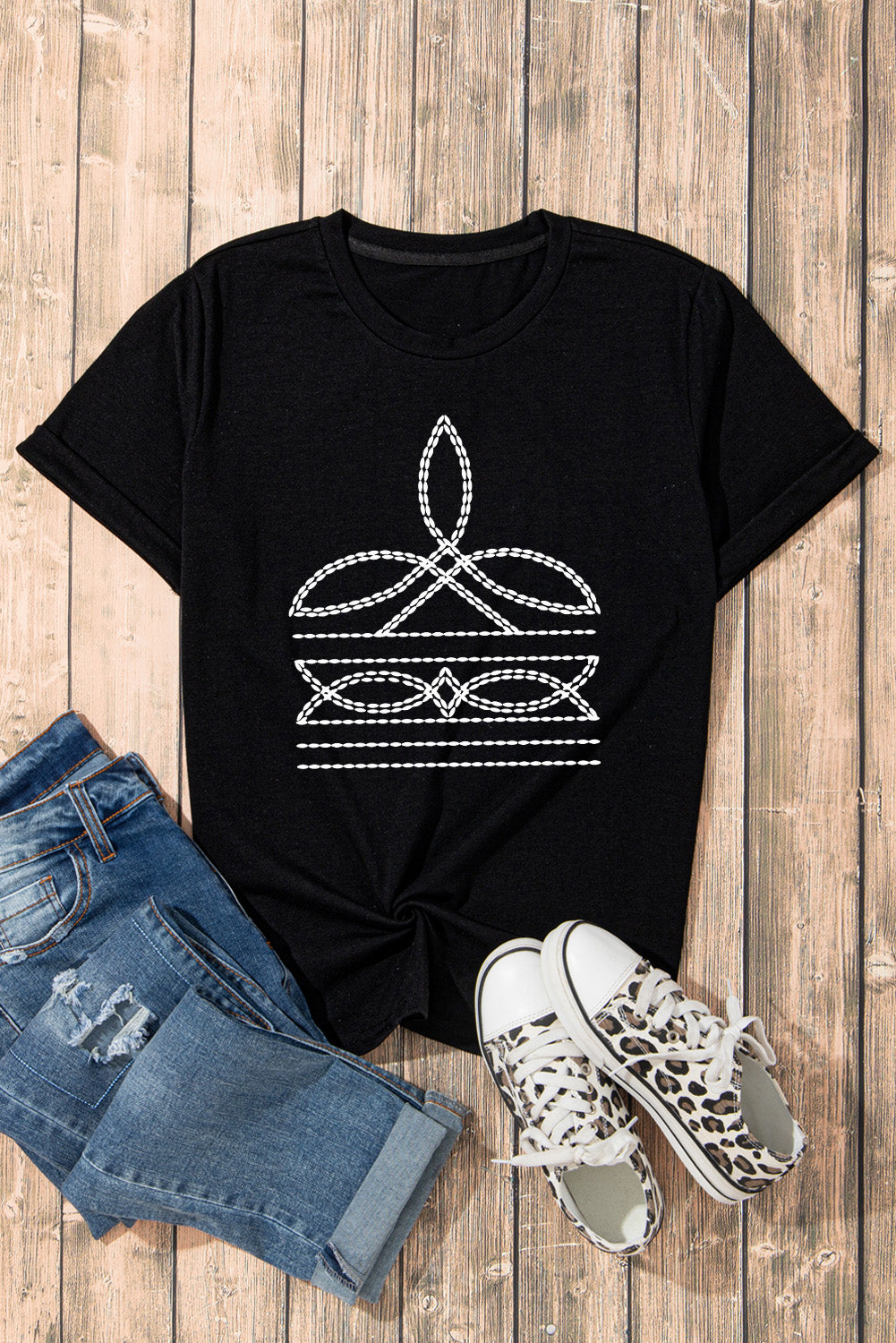 Black crew neck t-shirt with white embroidered graphic detail and rolled sleeves.