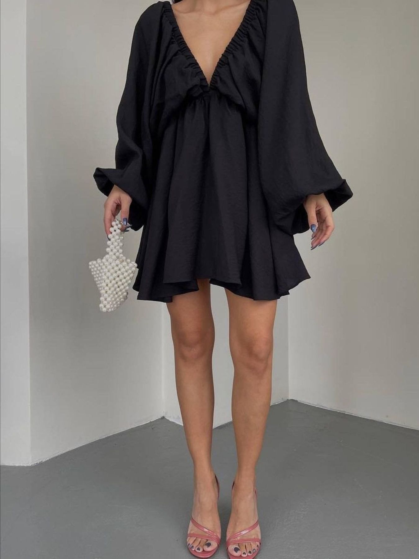 Black ruched V-neck dress with balloon sleeves and a flared skirt.