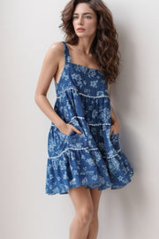 Floral denim tiered sundress in medium with white trim and pockets.