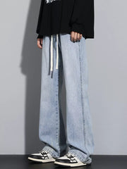 Men's light blue vintage wash jeans with drawstring waist and relaxed fit.