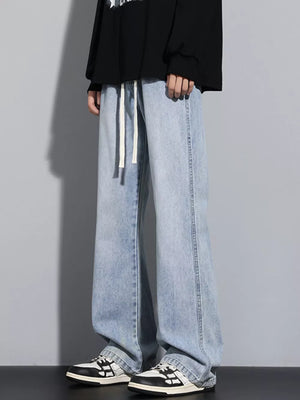 Men's light blue vintage wash jeans with drawstring waist and relaxed fit.