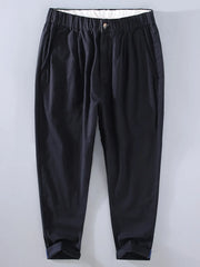 Men's black relaxed fit cropped sweatpants with elastic waist and cuffed hems.