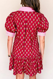Red floral mini dress with puff sleeves, ruffled hem, and pink collar.