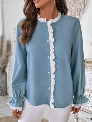 Light blue button-up blouse with white lace trim on the neckline and cuffs.
