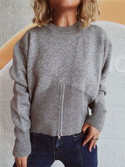 Gray ribbed zip-front knit sweater with a crew neck and long sleeves.