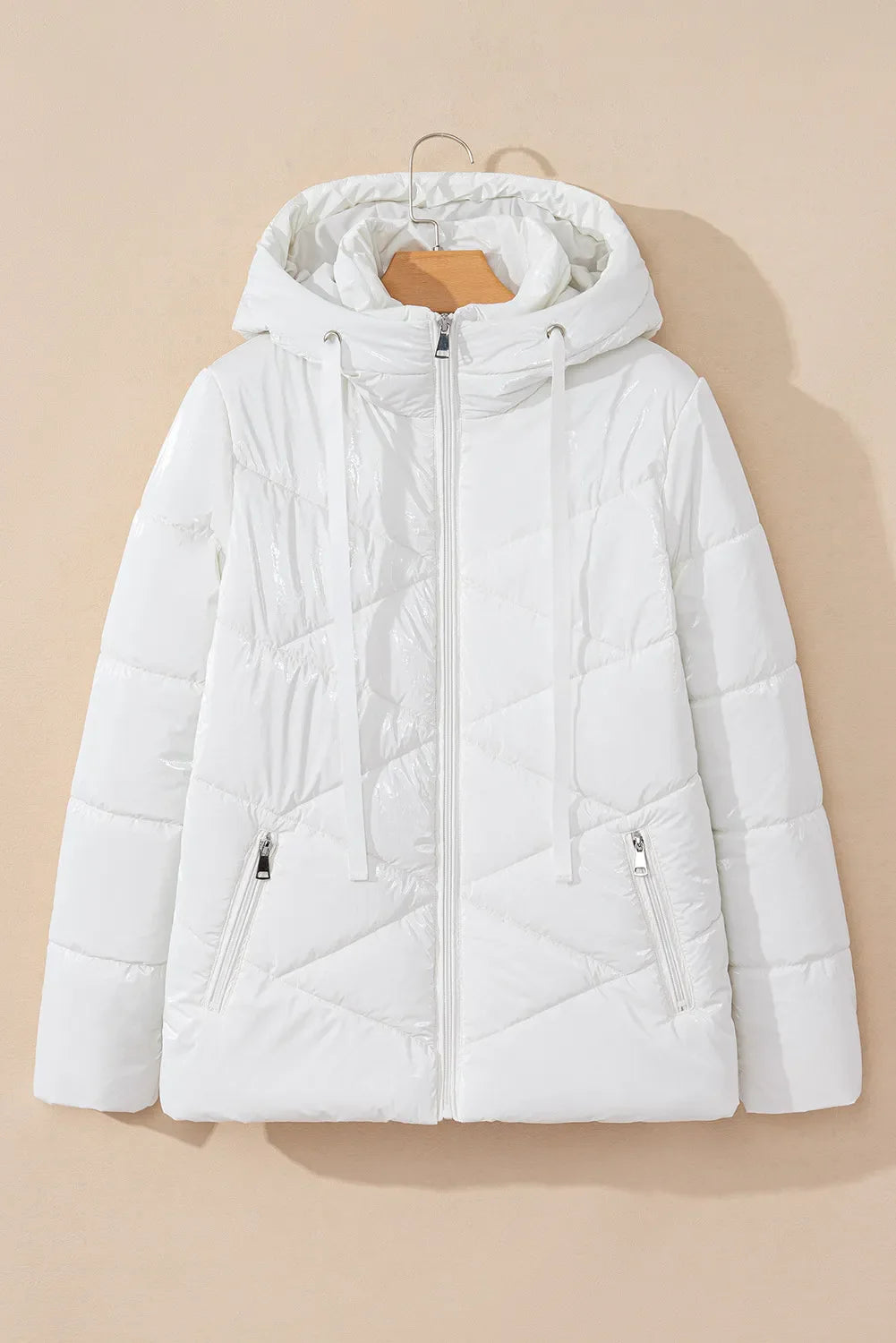 Glossy white quilted puffer jacket with a hood and zippered pockets.