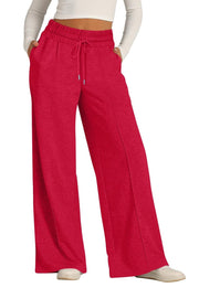 Seamed palazzo lounge trousers in red with drawstring waist and wide legs.