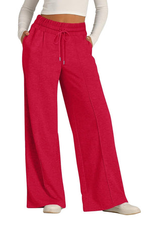 Seamed palazzo lounge trousers in red with drawstring waist and wide legs.