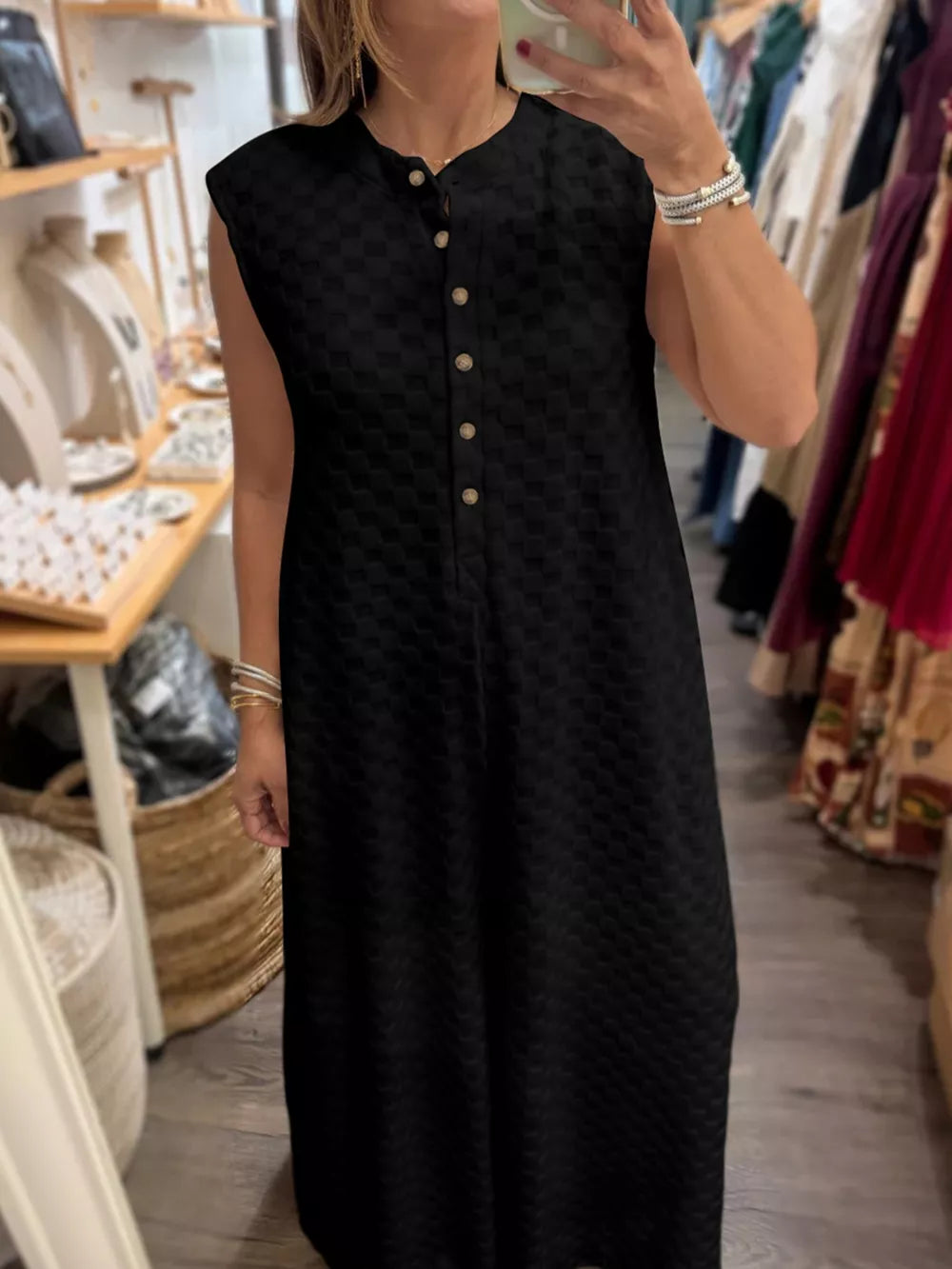 Chic black checkered wide-leg jumpsuit with button-front and mandarin collar.