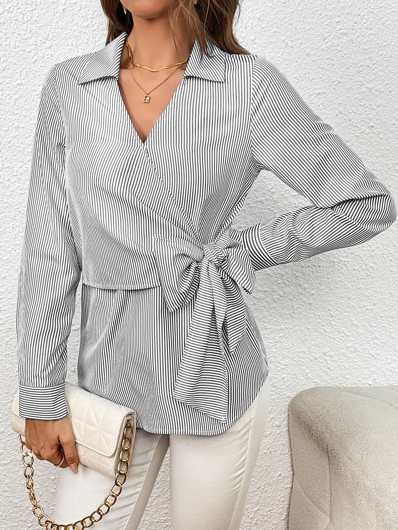 Striped wrap blouse with bow detail and collar.
