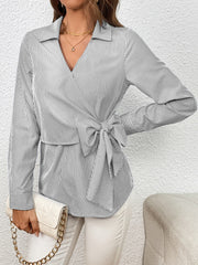 Striped wrap blouse with bow detail and collar.
