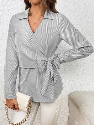 Striped wrap blouse with bow detail and collar.