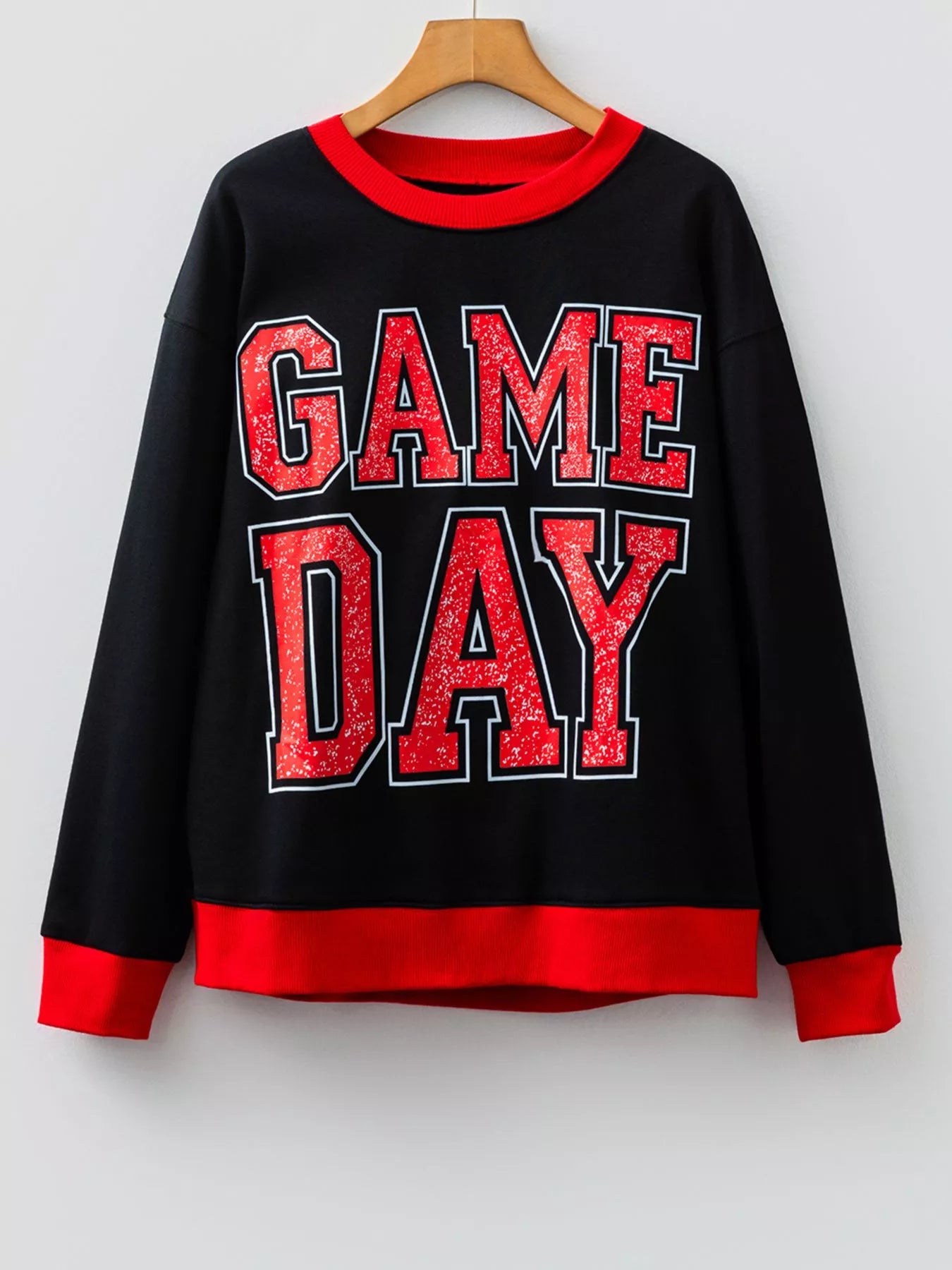 Black sweatshirt with red GAME DAY varsity lettering and red trim