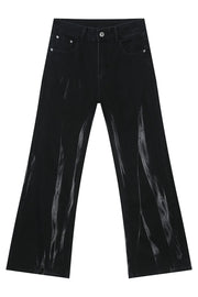 Faded flare denim jeans in dark wash with vertical distressed detailing.