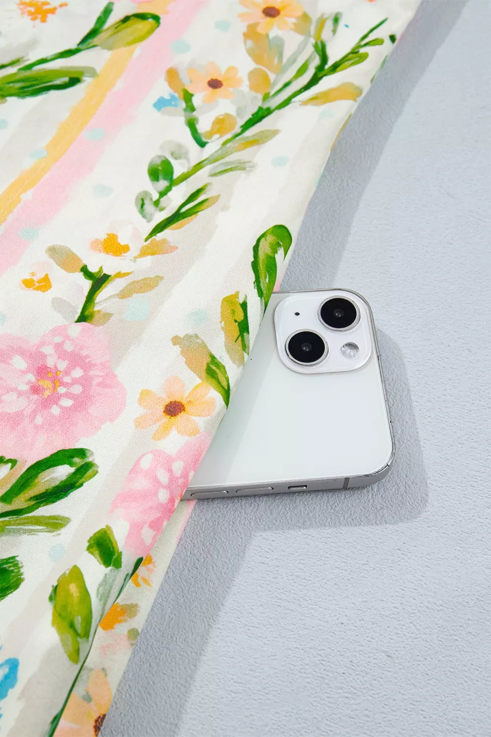 Floral print shift dress with pink and yellow stripes, showing a pocket detail.