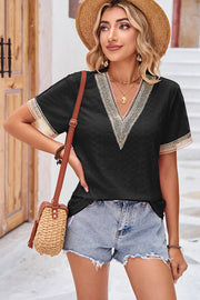 Black eyelet V-neck blouse with lace trim on neckline and sleeves