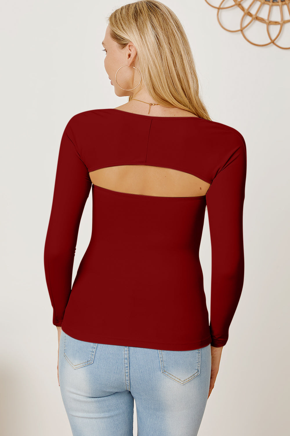 Burgundy long sleeve bodysuit with open back detail.