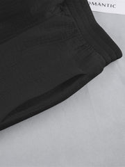 Black textured cotton lounge shorts with elastic waistband and side pocket detail.