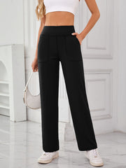 Black wide-leg lounge trousers with patch pockets and a high waist.