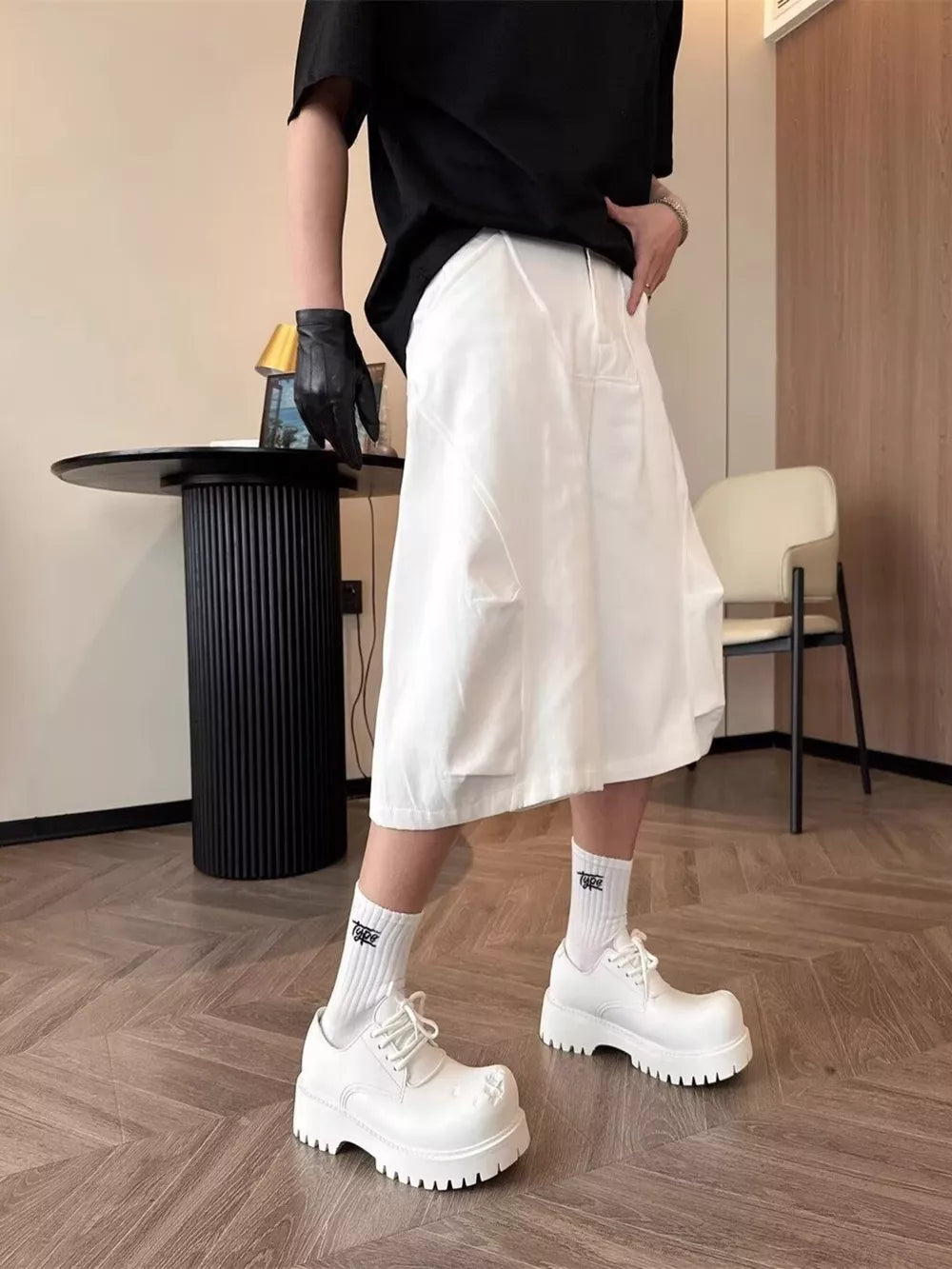 Relaxed white cargo cropped pants with multiple pockets and a wide leg.
