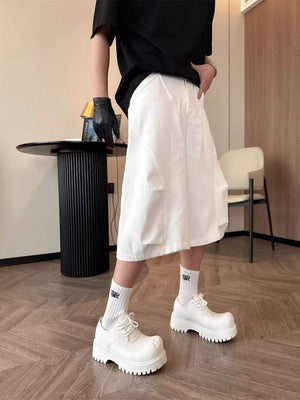Relaxed white cargo cropped pants with multiple pockets and a wide leg.