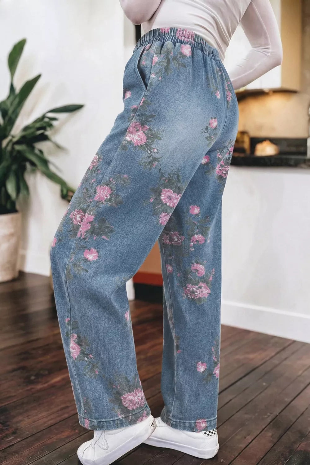Floral wide-leg denim jeans with elastic waistband and pink floral print.