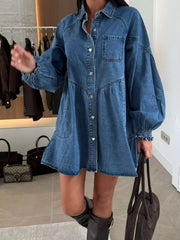Blue denim mini dress with pockets, button-down front, and voluminous sleeves.