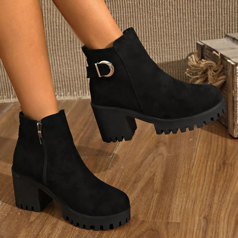 Black suede ankle boots with block heel, side zipper, and decorative buckle detail.