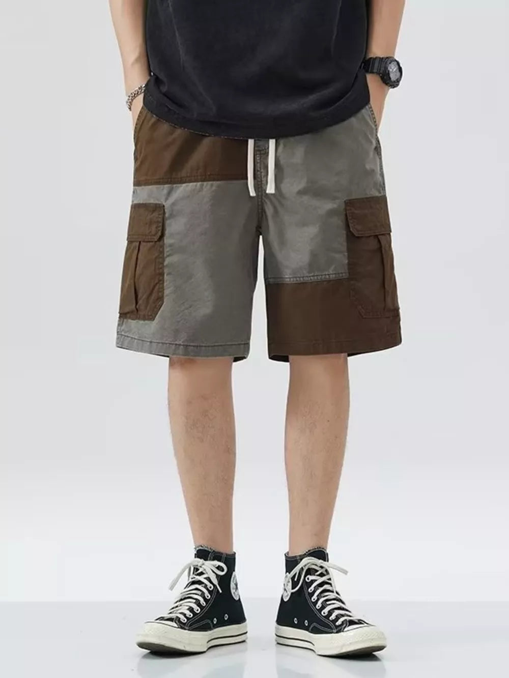 Two-tone cargo shorts with drawstring and button flap pockets, above the knee length.