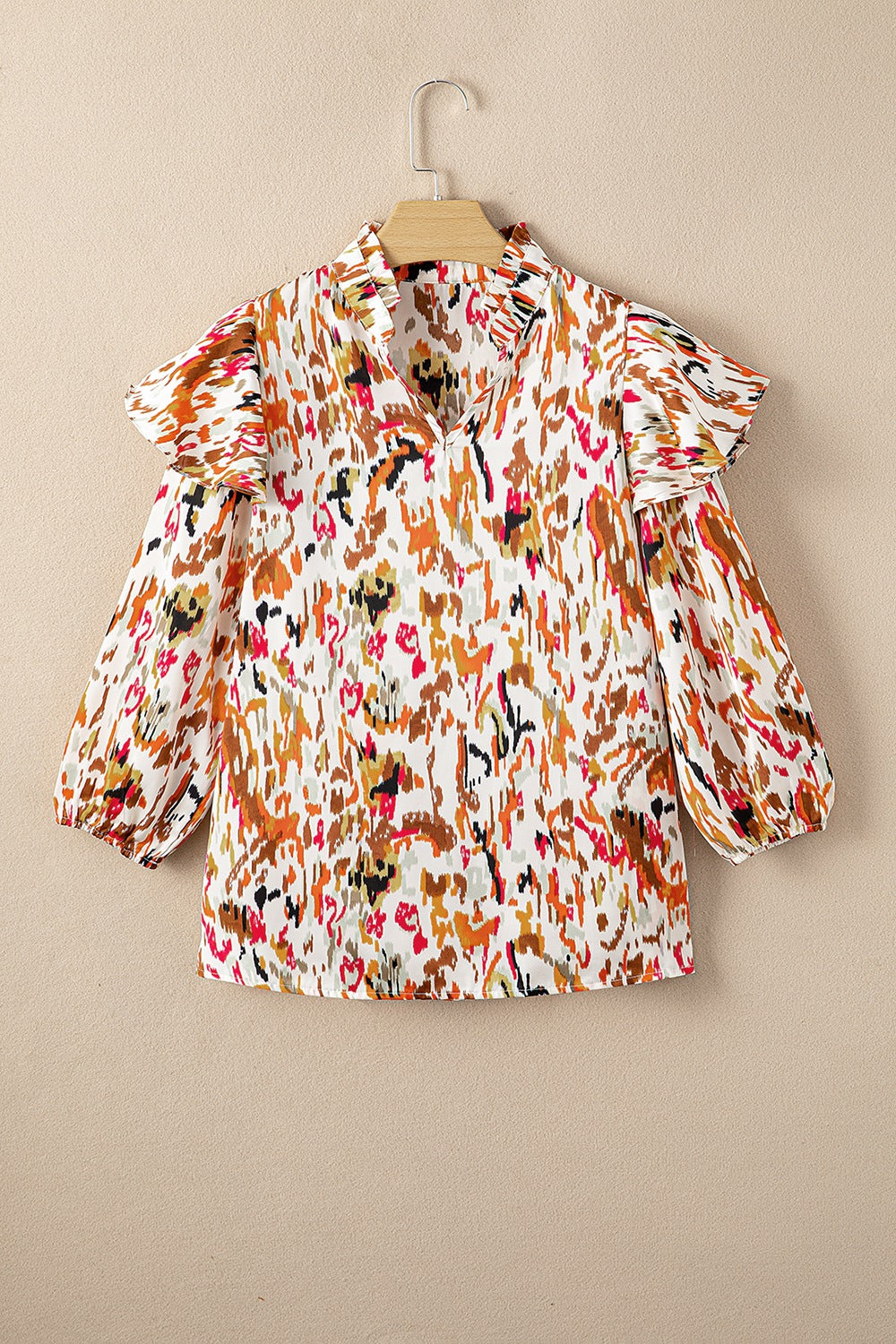 Ruffled Aura Sleeve Blouse in abstract print with ruffled neckline and balloon sleeves.