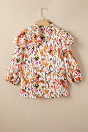Ruffled Aura Sleeve Blouse in abstract print with ruffled neckline and balloon sleeves.