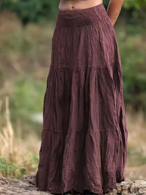 Burgundy tiered maxi skirt with smocked waist, flowy bohemian style.