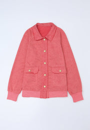 Washed cotton utility jacket in burnt coral with two chest pockets and gold buttons.