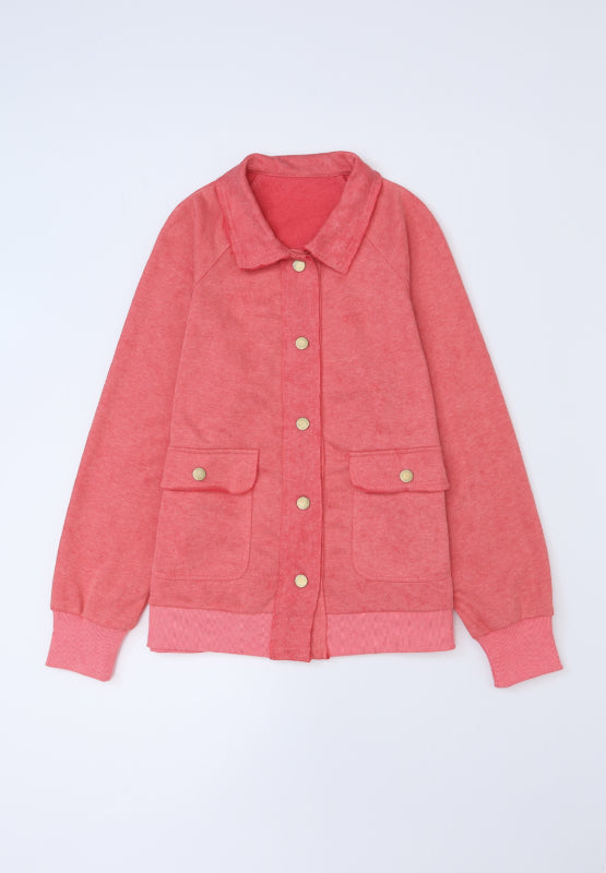 Washed cotton utility jacket in burnt coral with two chest pockets and gold buttons.