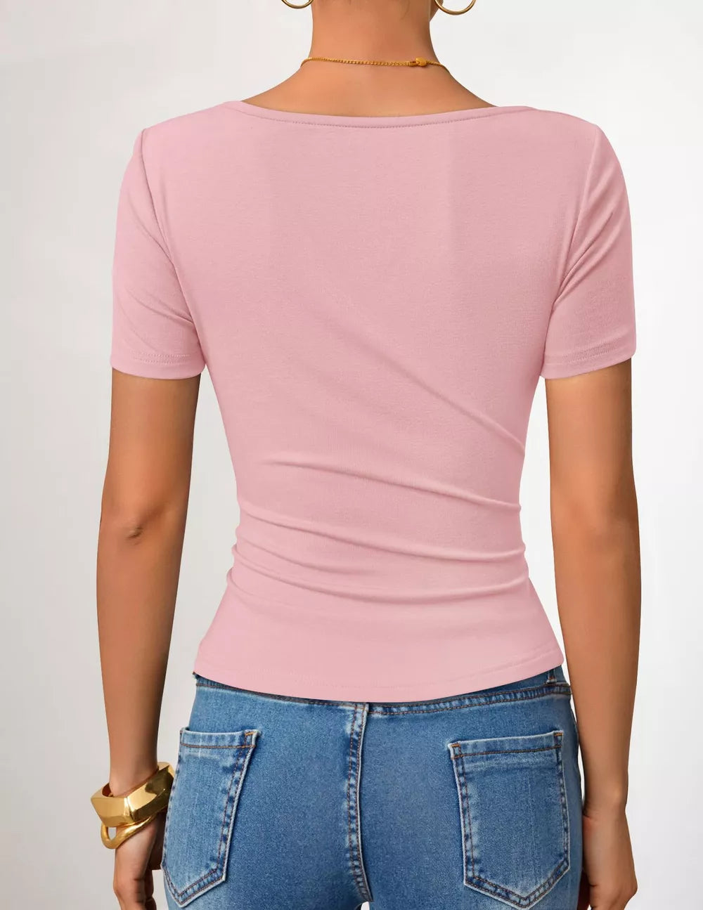 Pink maternity t-shirt with short sleeves and a fitted silhouette, showing the back detail.