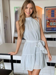 Sky blue mini dress with halter neckline, tie waist, and tiered skirt.