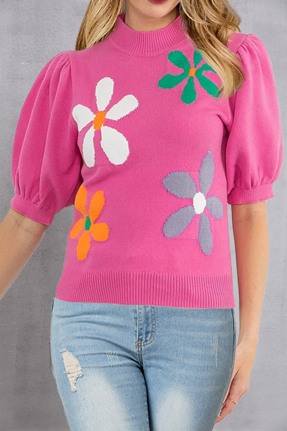 Pink knit top with puff sleeves and colorful floral appliques