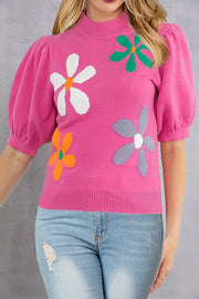 Pink knit top with puff sleeves and colorful floral appliques