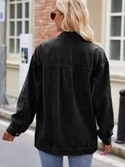 Black denim oversized shacket with button cuffs and collar detail.