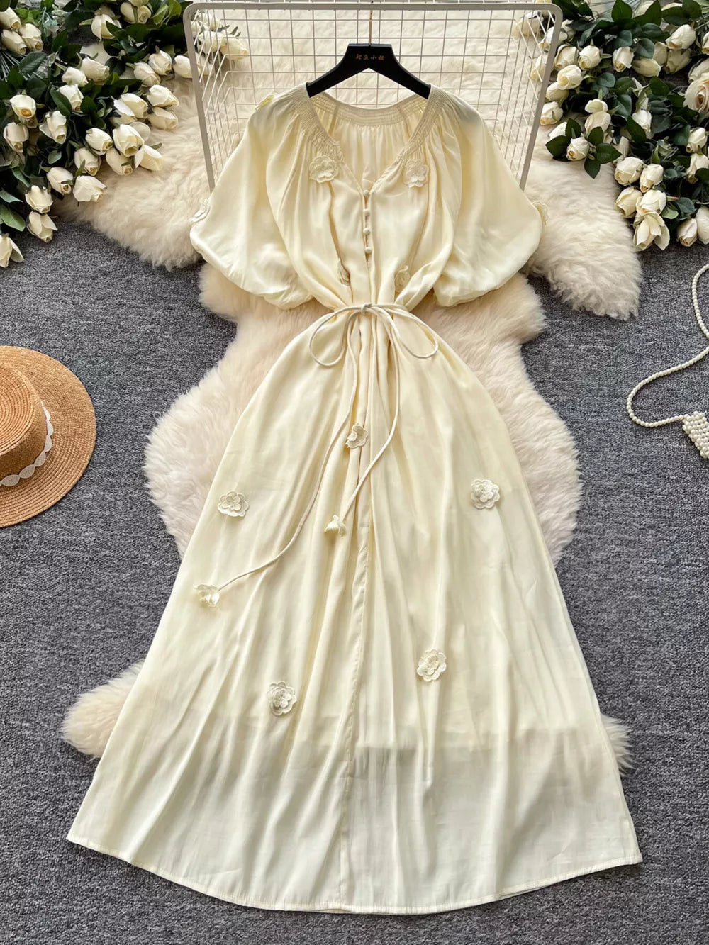 Apricot floral maxi dress with puff sleeves, tie waist, and button front.