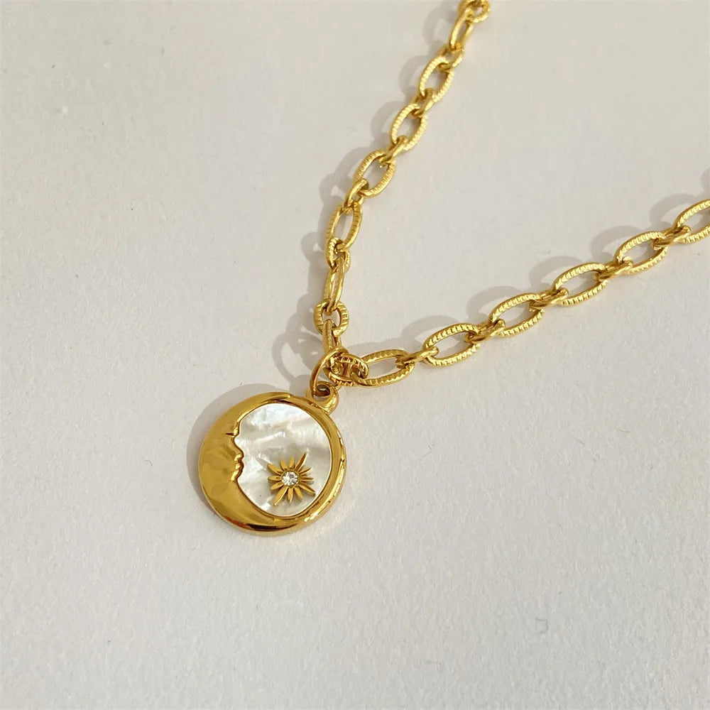 Gold chain necklace with moon and sun medallion, mother of pearl inlay, celestial detail