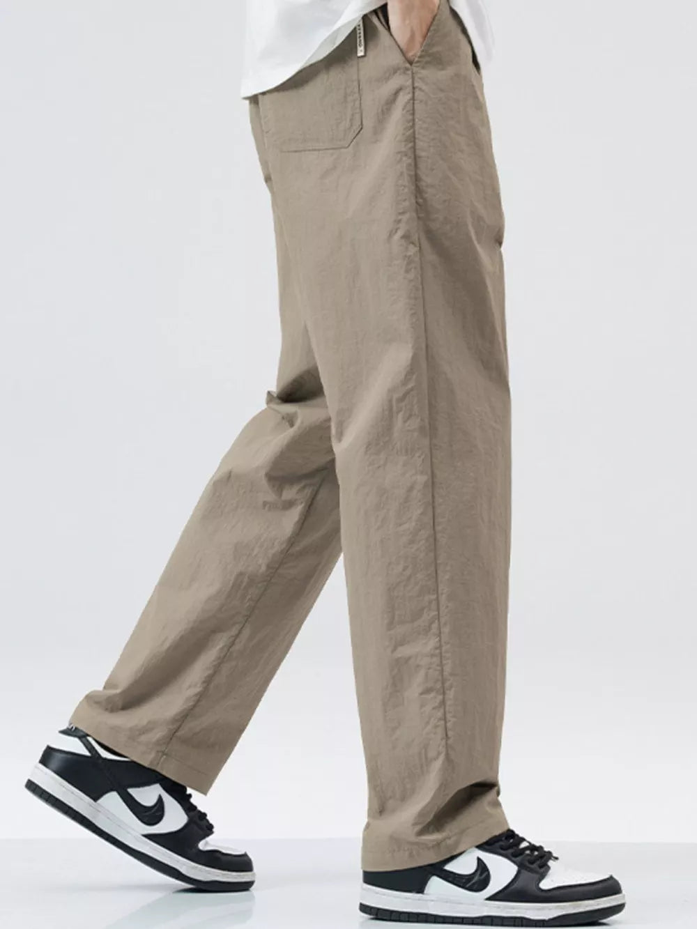 Khaki relaxed fit wide-leg sweatpants with pockets, styled casually.