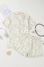 Ivory floral print pajama set with button-up top and shorts, featuring pink trim.