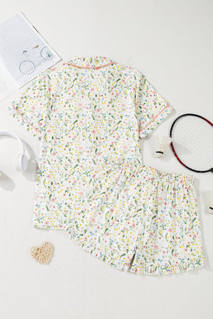 Ivory floral print pajama set with button-up top and shorts, featuring pink trim.
