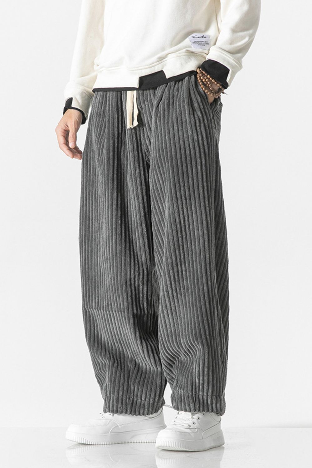 Gray corduroy wide-leg cargo pants with a relaxed fit and drawstring waist.