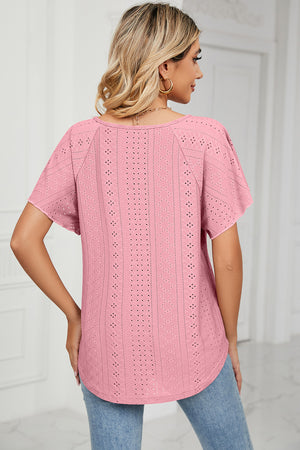 Pink eyelet blouse with flutter sleeves and a tie-neck detail.