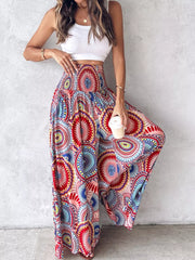 Bohemian print wide-leg pants with smocked waist in red, blue, and yellow.